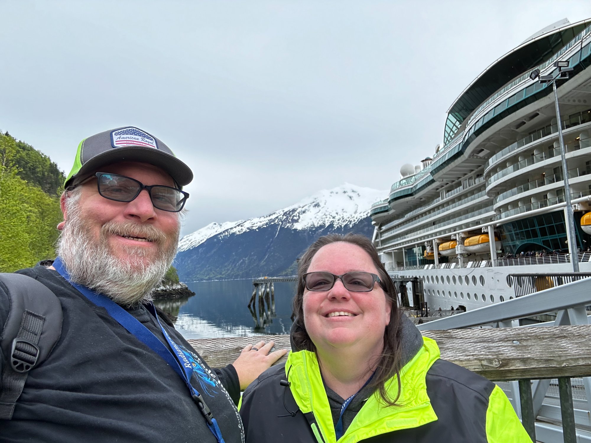 Patrick Diller at an Alaska cruise port with snow-capped mountains in the background